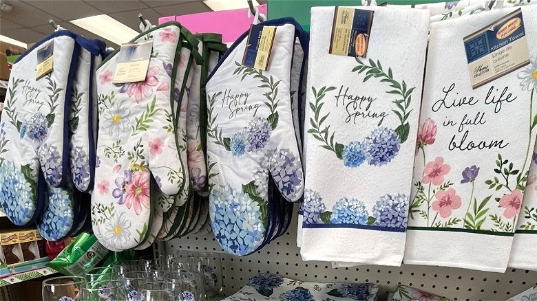 Spring-themed kitchen towels and mitts on hangers at Dollar Tree.