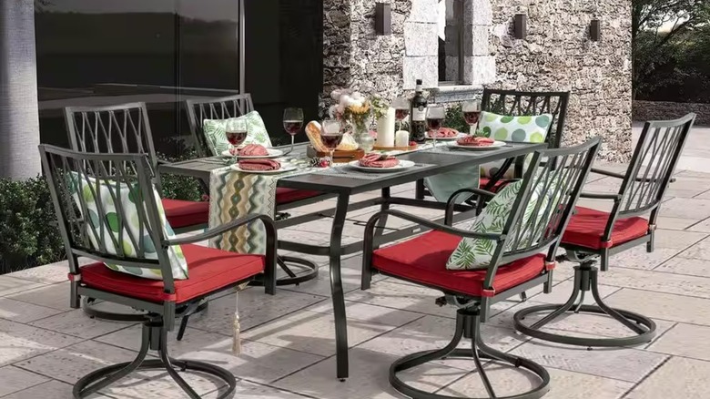 Metal patio dining table and chairs set on a paver patio