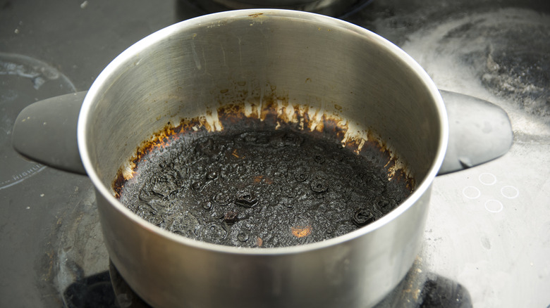 Metal pot with scorched bottom