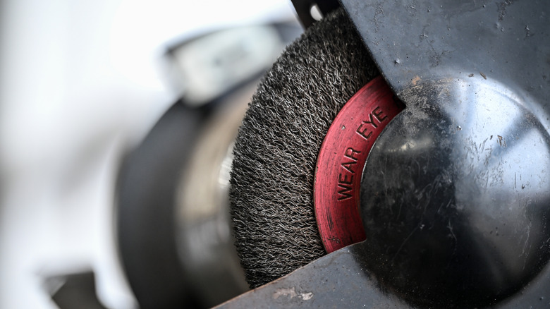 A wire wheel mounted to a bench grinder