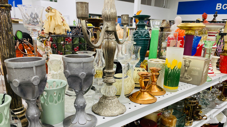 Candle holders on a thrift store shelf