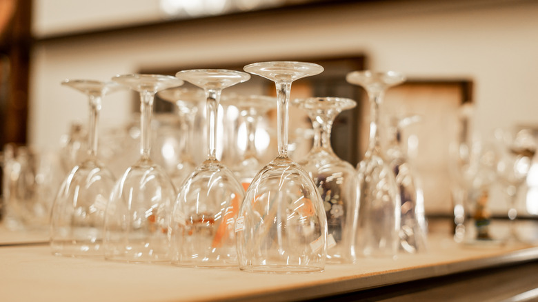 Glasses with stems sitting upside down in a secondhand store