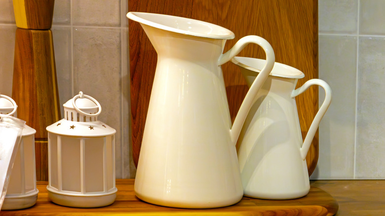 White retro pitchers on a wood surface