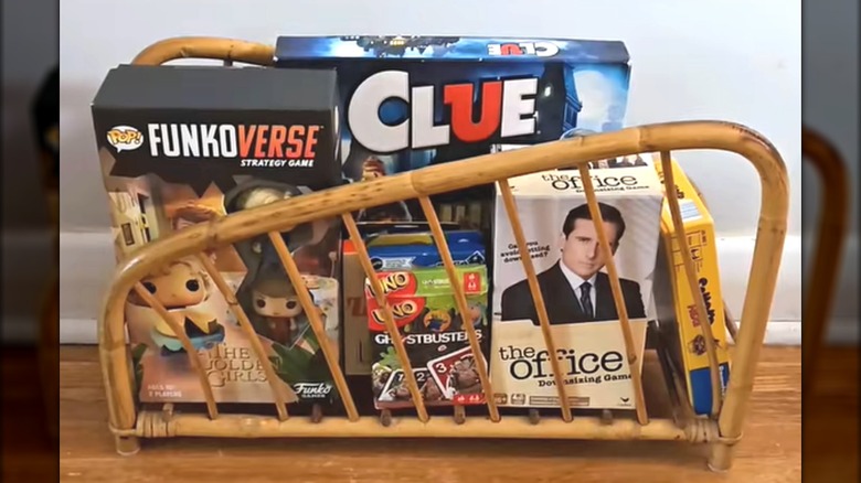 Modern board games stocked in wicker magazine holder