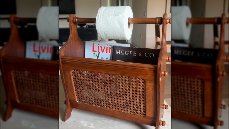 Toilet paper roll tucked over retro, wooden magazine case