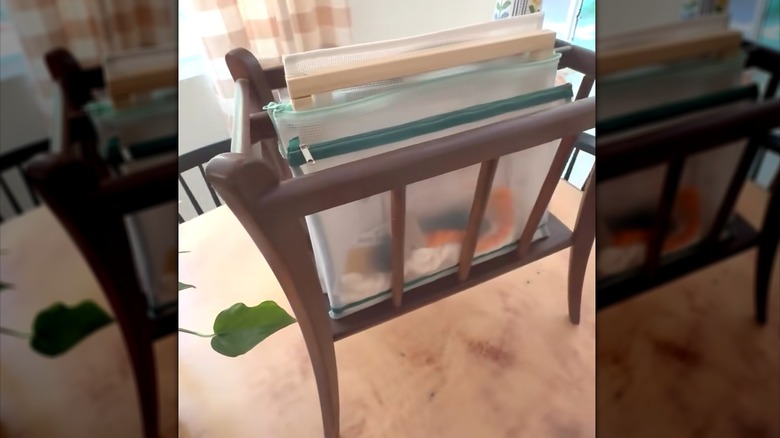 Wood rack with pouches of sewing supplies and crafting material