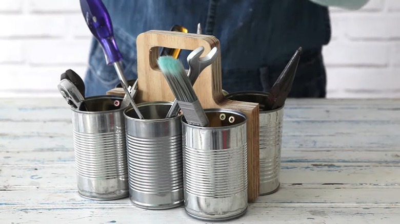 DIY portable tool organizer made out of soup cans and wood board