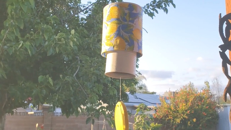 Hanging blue and yellow wind chime made of metal cans