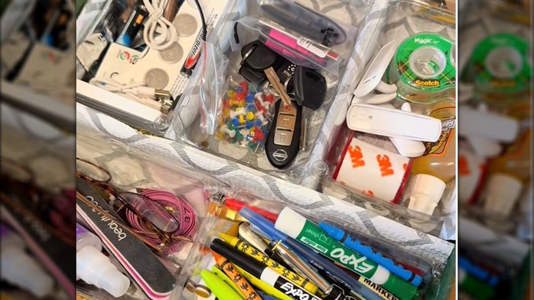 House junk drawer separated by DIY plastic dividers