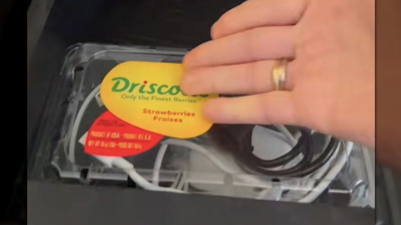 Loose cables curled up in plastic strawberry carton