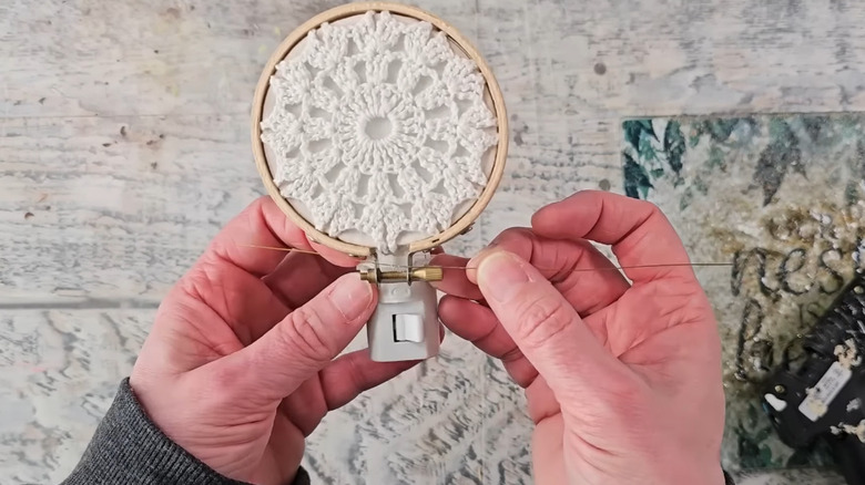 A doily affixed to the front of a night light.