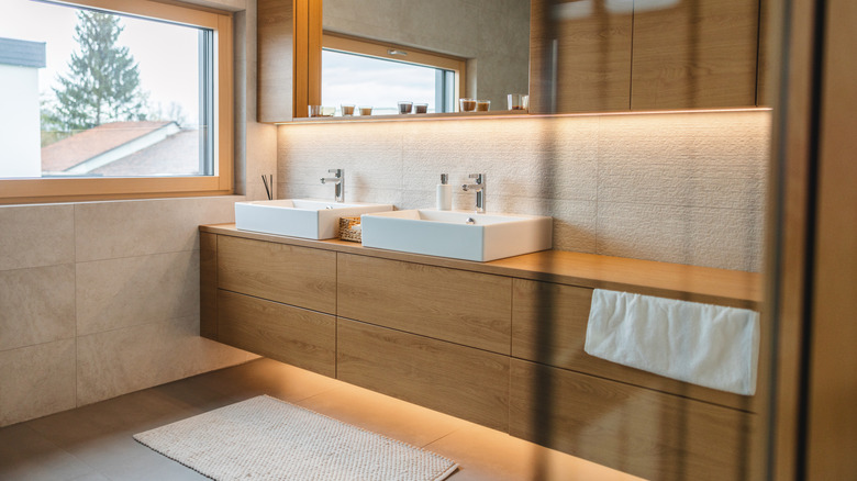 Bathroom sink area with completely flat cabinet doors