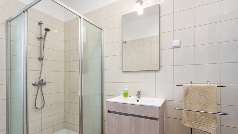 Bathroom with a single bright light over the mirror