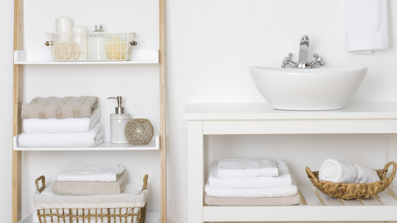 A sink with open shelving below and to the side