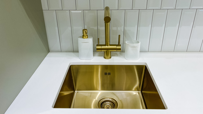 A polished brass sink and faucet