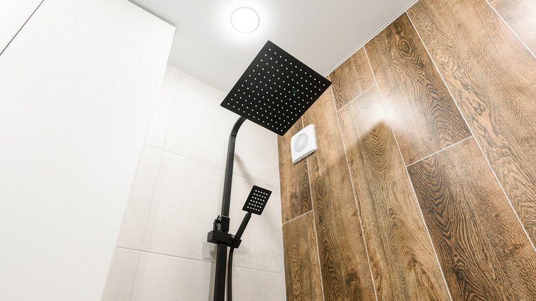 A shower with a wood-like tile wall