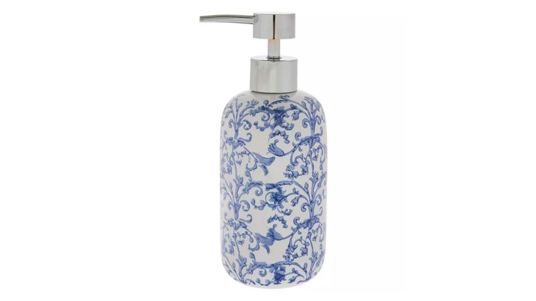 A blue floral ceramic soap dispenser is shown in a detail shot