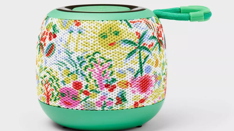 A small bluetooth speaker is covered in a colorful Roller Rabbit design