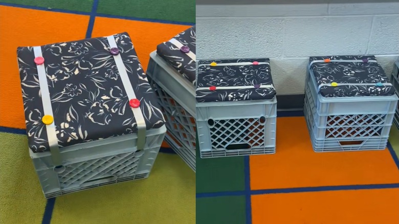 Gray milk crates with cushioned seating and decorative button straps on colorful carpet