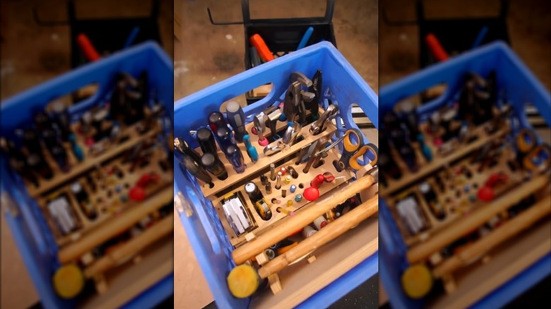 Assorted and organized hand tools in blue milk crate with custom wood insert