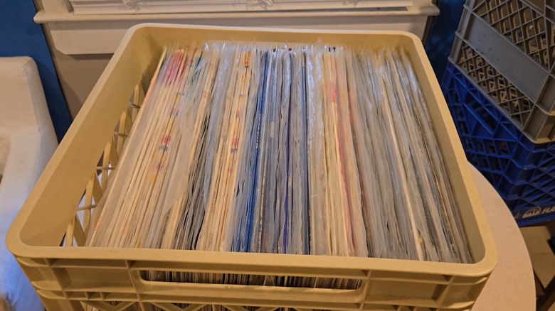 Organized and sealed musical records stowed in beige milk crate
