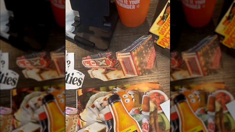 Magazine pictures and ads cut out on wood table