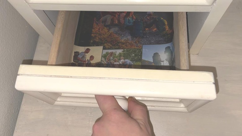 Small desk drawer with camping magazine pages used as drawer liner