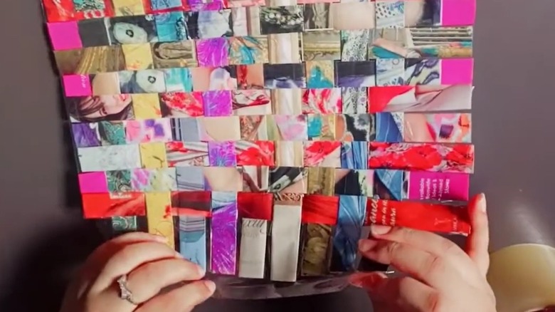 Woman crafting handmade placemat from folded magazine pages