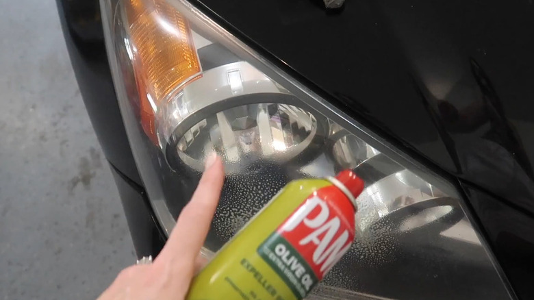 Removing insects from a car's headlights with Pam cooking spray