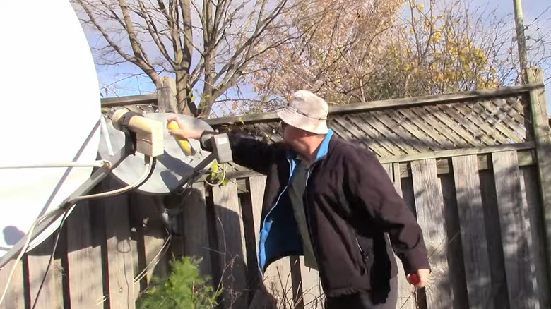 Applying Pam cooking spray to as satellite dish