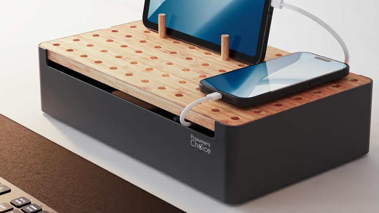 A Prosumer's Choice Charging Station on a desk with a tablet and phone plugged in