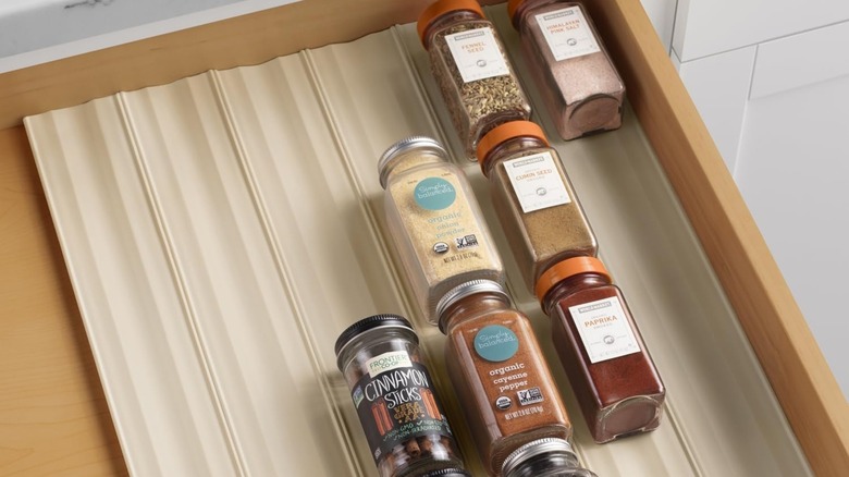 A YouCopia SpiceLiner Spice Rack Drawer Organizer in a kitchen drawer