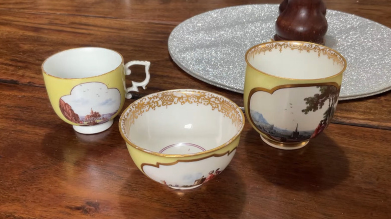 A trio of vintage Meissen cups in different sizes on a table