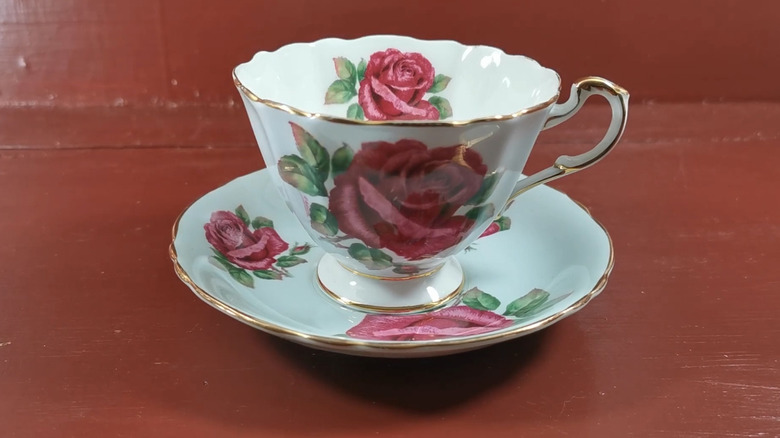 Paragon cabbage rose teacup on a red table
