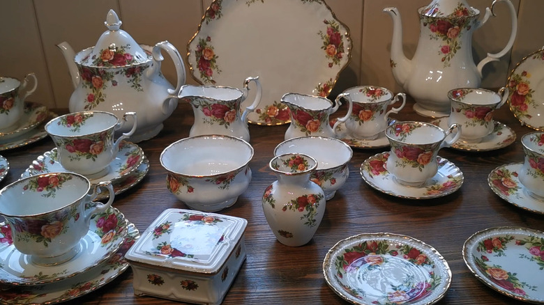 A full set of Royal Albert teacups, saucers, teapots, and containers for sugar and cream.