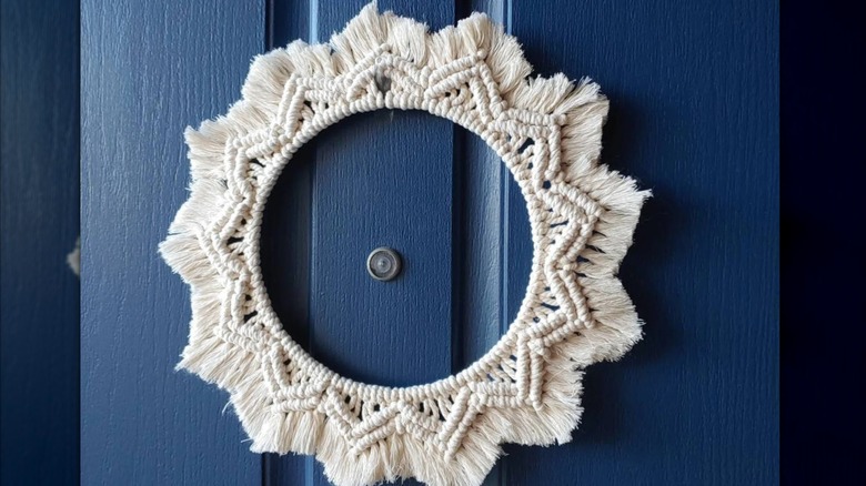 Macramé wreath around peephole on front door
