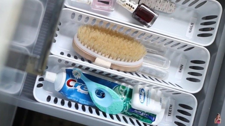 Small baskets in a drawer with various items
