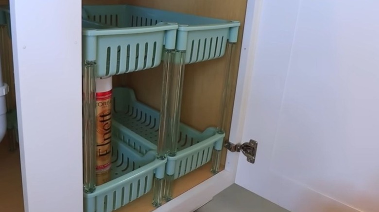 Two stacking shelves side by side under a bathroom sink