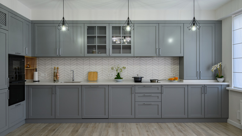 Empty kitchen with cabinets that are all gray