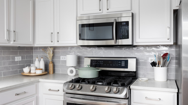 Microwave installed above a kitchen stove