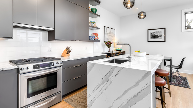 Kitchen with a marble island waterfall countertop