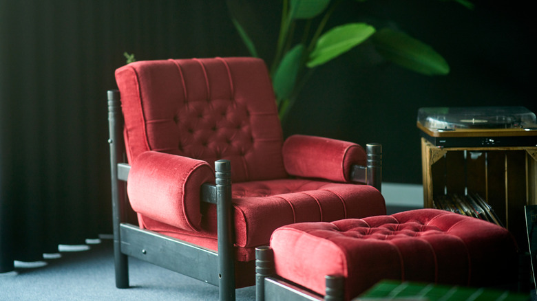 Red chair and footstool in a green room