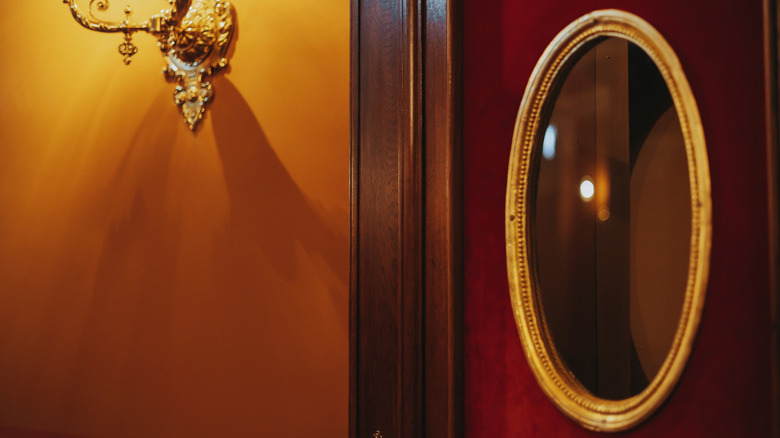 Gilded mirror and wall sconce