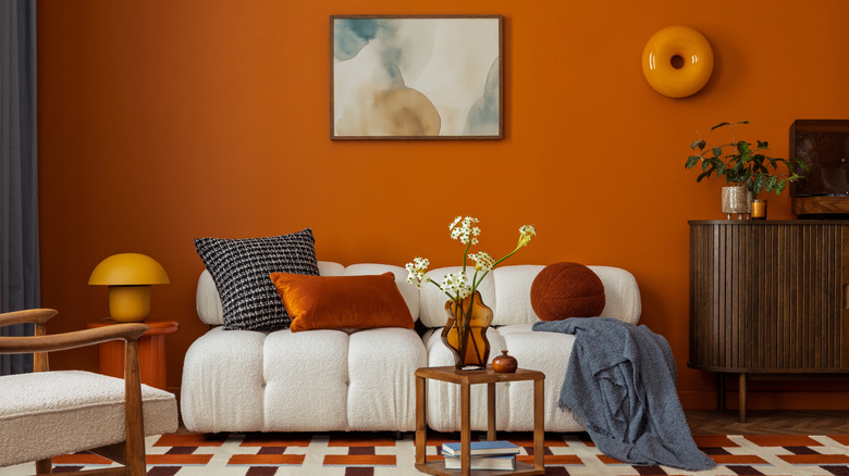 A living room decorated with orange retro decor