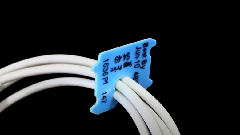 A bundle of cables tied up with a bread tag.