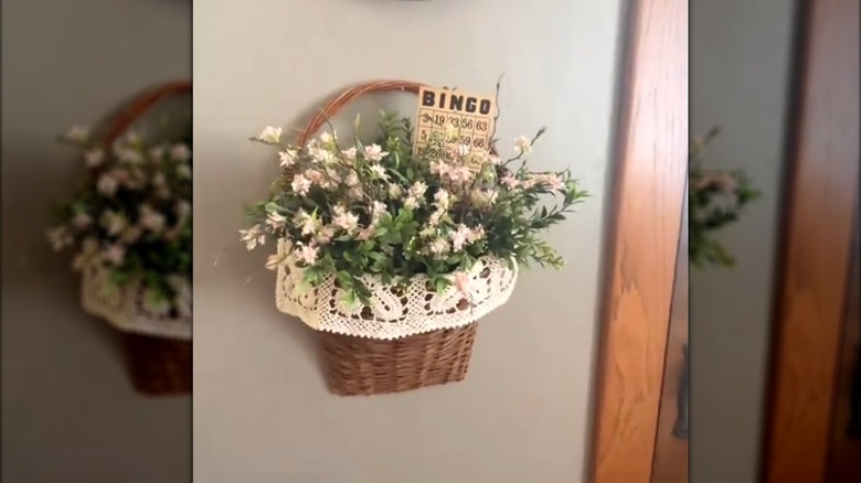 Hanging woven basket with flowers and doily lining in traditional farmhouse-style home