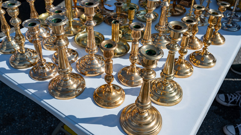 A table of candlesticks at a flea market