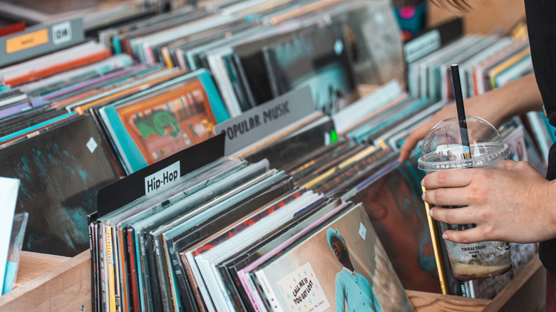 Person browsing stacks of records