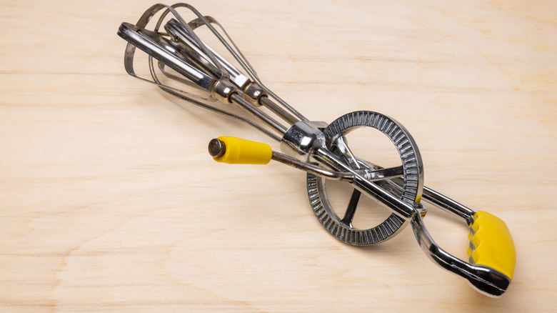 Yellow handled mechanical egg beater