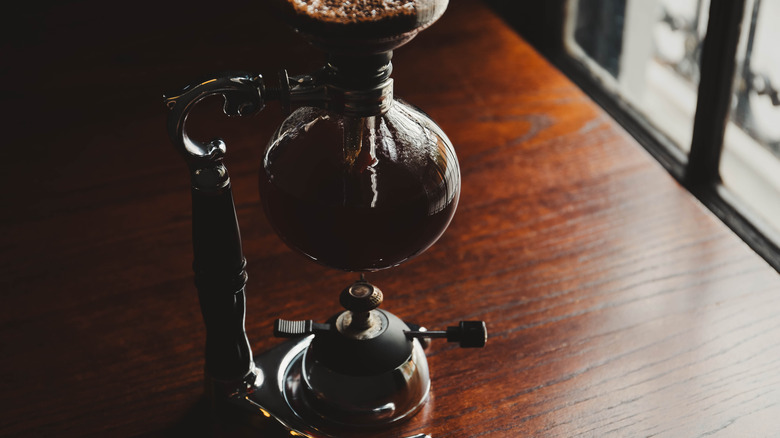 Vacuum coffee pot on wooden table